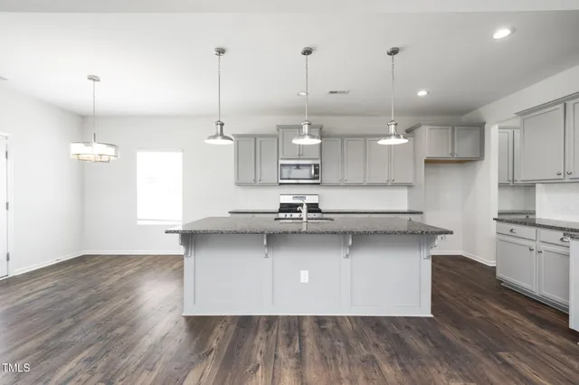 a view of kitchen and hall with wooden floor