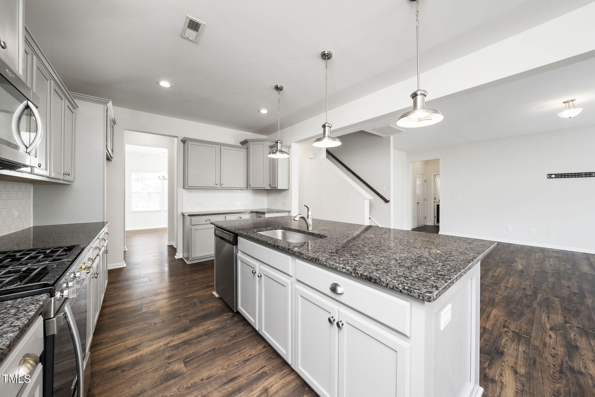 5502 Ripplebrook Drive Durham, NC 27712 - Photo 19 of 50 a kitchen with stainless steel appliances granite countertop a stove a sink and a refrigerator