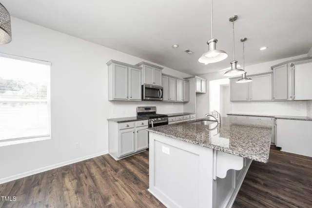 a view of kitchen with sink and wooden floor