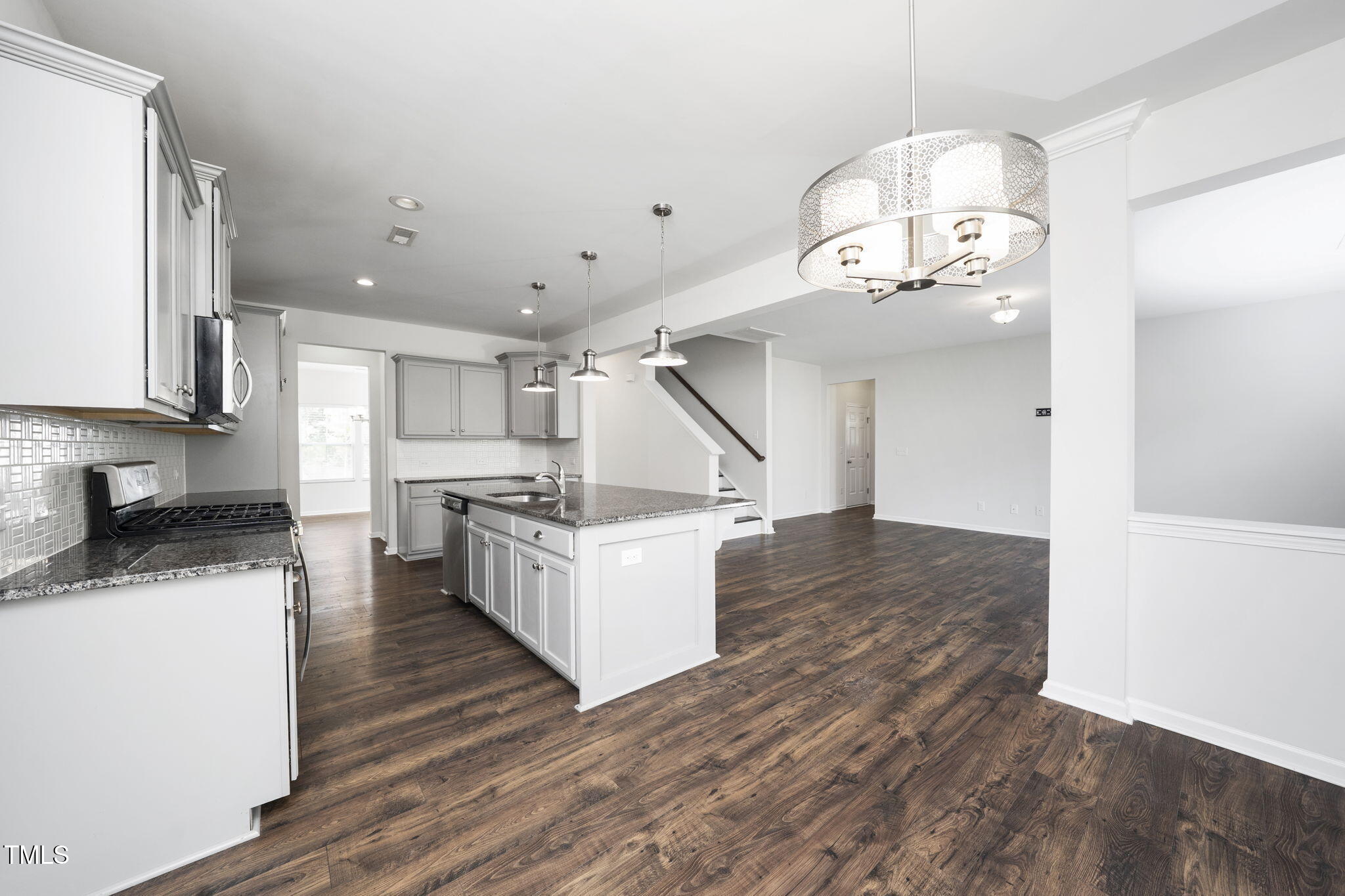 5502 Ripplebrook Drive Durham, NC 27712 - Photo 22 of 50 a kitchen with a sink cabinets and wooden floor