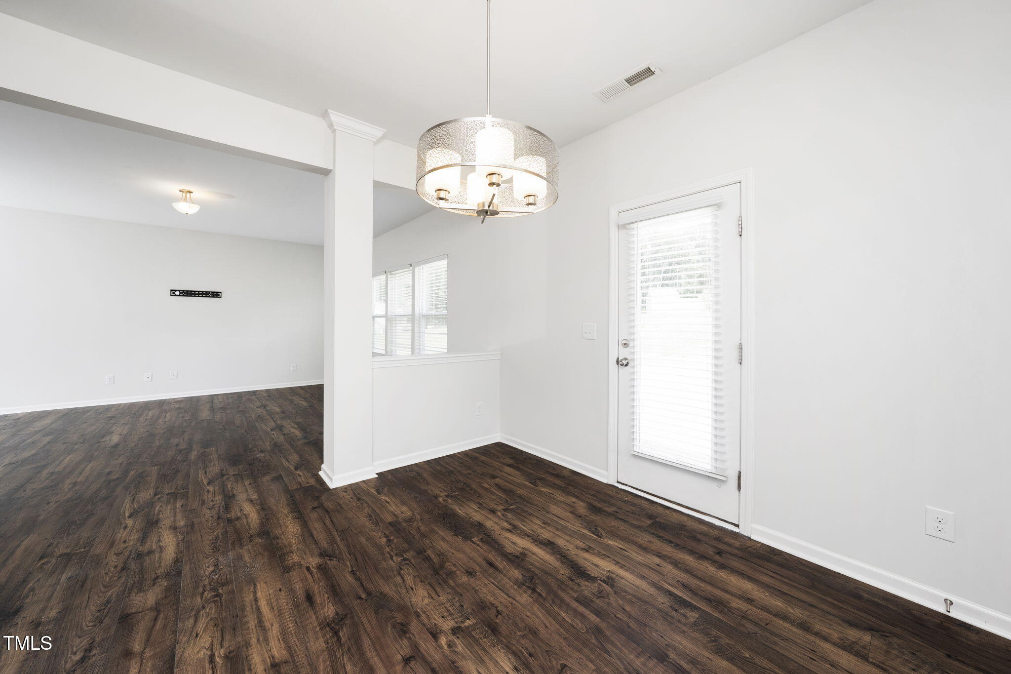 5502 Ripplebrook Drive Durham, NC 27712 - Photo 25 of 50 an empty room with wooden floor and windows