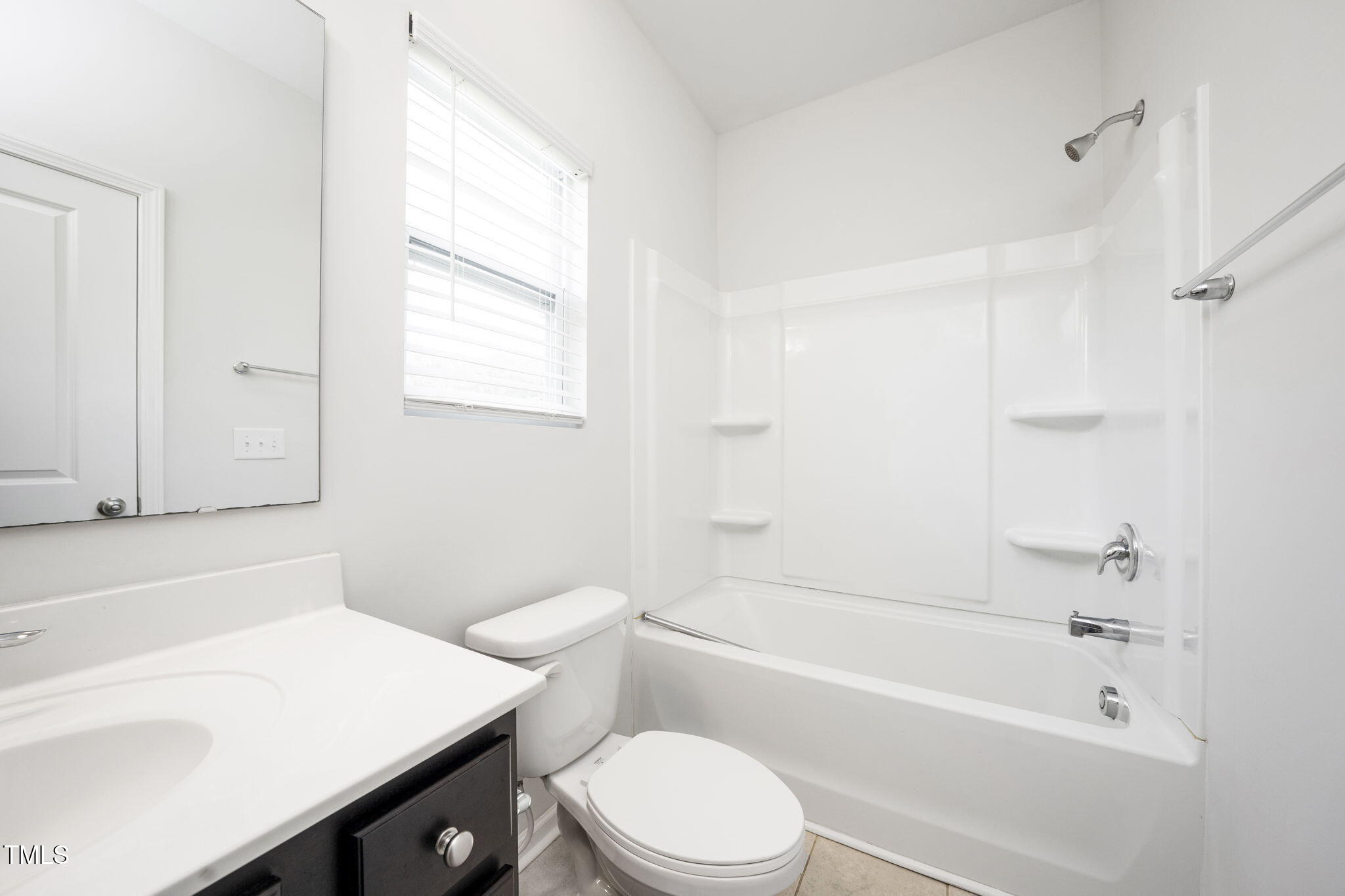 5502 Ripplebrook Drive Durham, NC 27712 - Photo 29 of 50 a bathroom with a sink a toilet and a bathtub