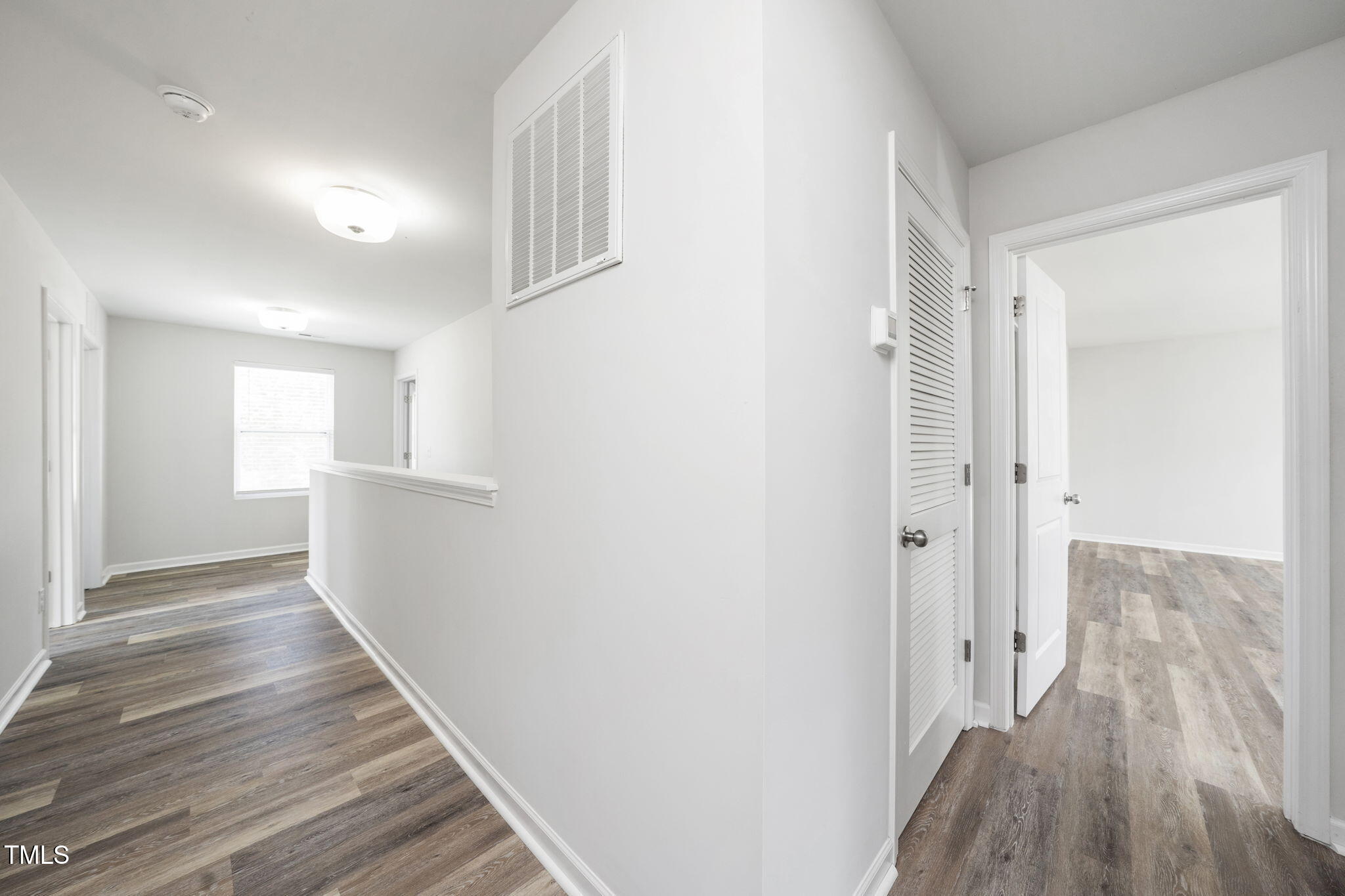 5502 Ripplebrook Drive Durham, NC 27712 - Photo 34 of 50 a view of a hallway with wooden floor and staircase