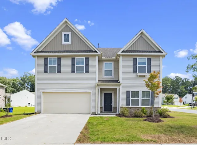 a front view of a house with a yard