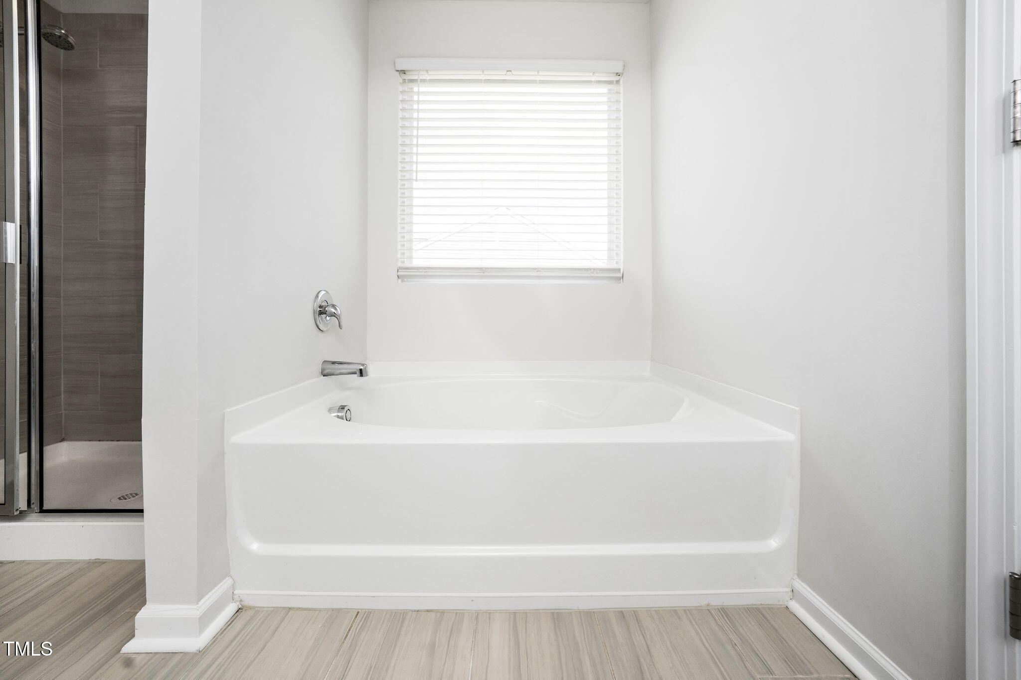 5502 Ripplebrook Drive Durham, NC 27712 - Photo 41 of 50 a white bath tub sitting next to a window