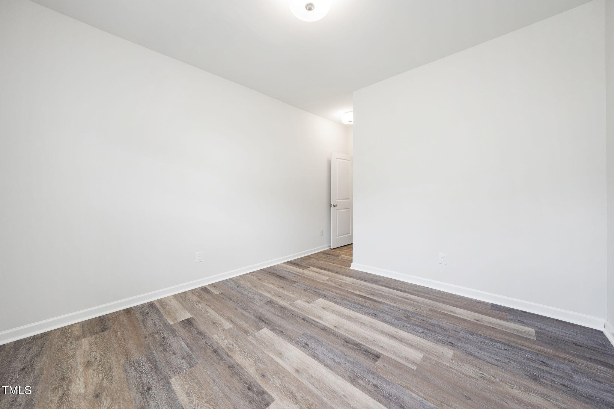 5502 Ripplebrook Drive Durham, NC 27712 - Photo 43 of 50 a view of an empty room with wooden floor