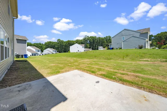 a view of a house with a backyard