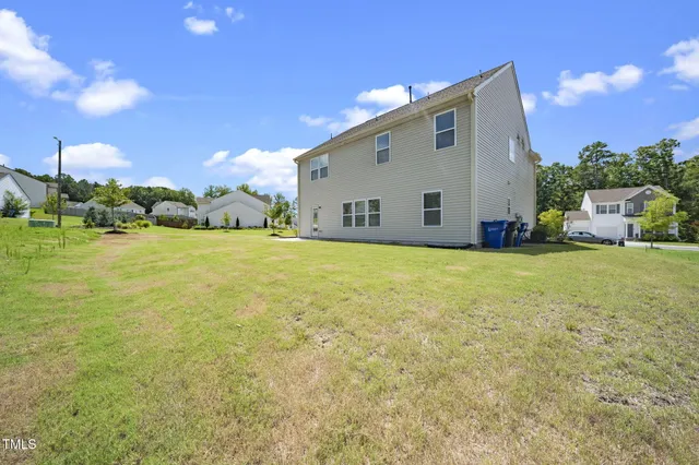 a view of an house with a backyard space