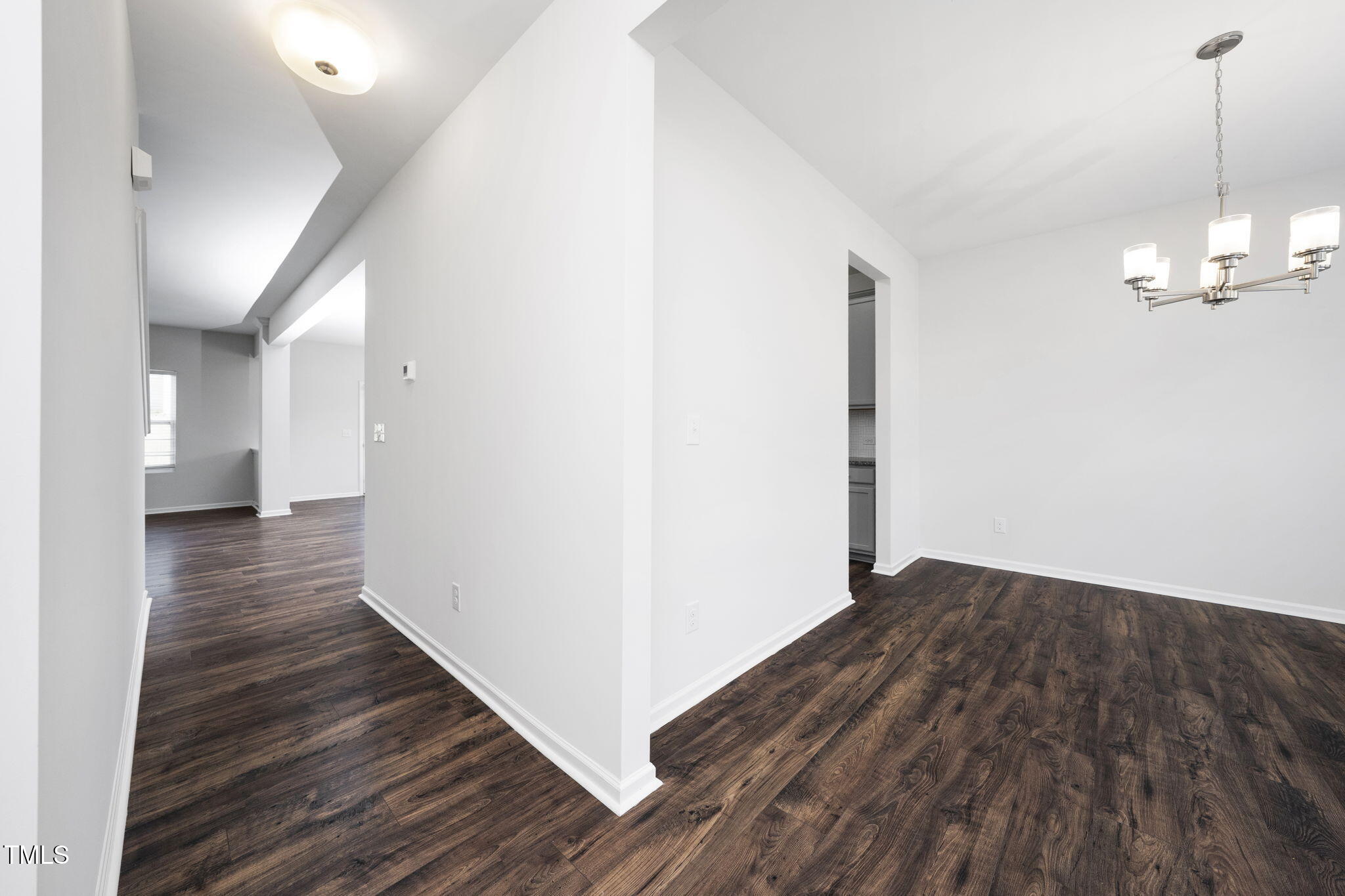 5502 Ripplebrook Drive Durham, NC 27712 - Photo 6 of 50 a view of a hallway with wooden floor