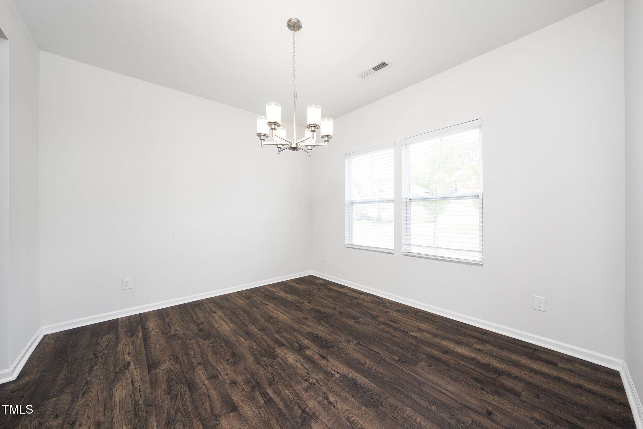 5502 Ripplebrook Drive Durham, NC 27712 - Photo 7 of 50 an empty room with wooden floor and windows