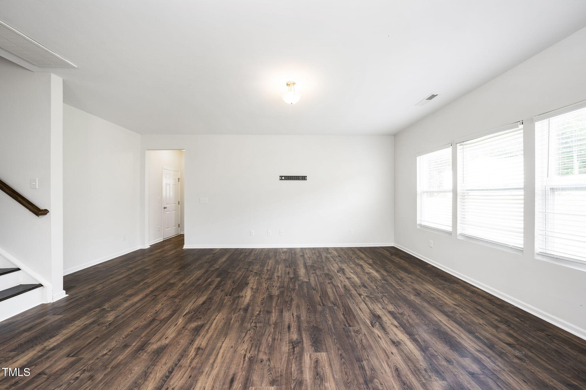 5502 Ripplebrook Drive Durham, NC 27712 - Photo 9 of 50 an empty room with wooden floor and windows