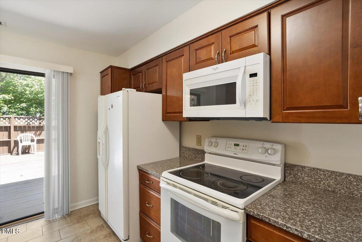 163 Springberry Lane Chapel Hill, NC 27517 - Photo 6 of 32 a kitchen with a stove and a microwave