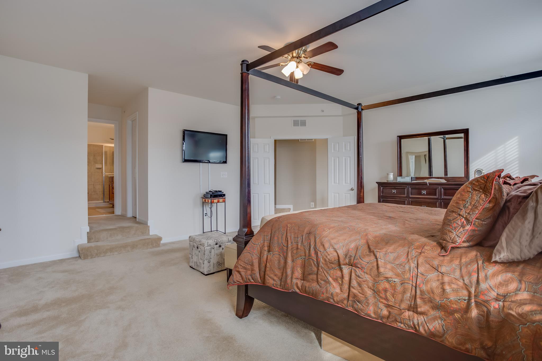 3437 Eagle Ridge Drive Woodbridge, VA 22191 - Photo 17 of 40 a bedroom with a bed and a flat tv screen on dresser