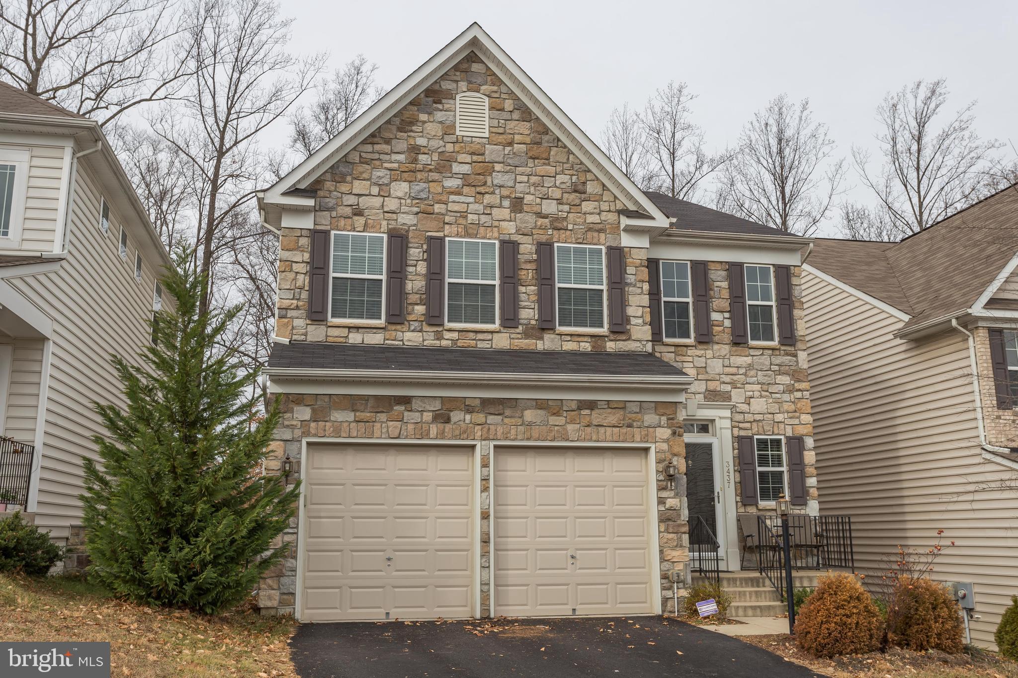 3437 Eagle Ridge Drive Woodbridge, VA 22191 - Photo 2 of 40 a view of a house with a yard and garage