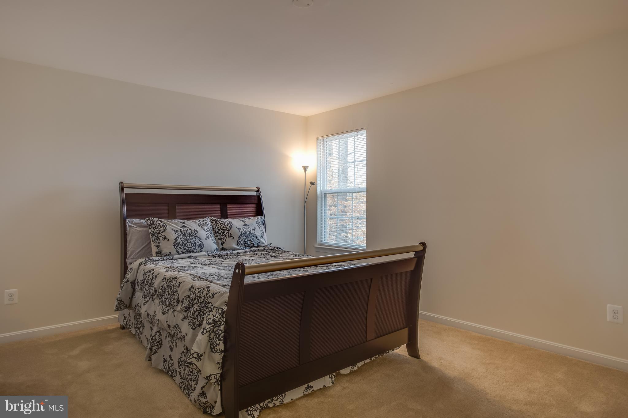 3437 Eagle Ridge Drive Woodbridge, VA 22191 - Photo 22 of 40 a bed sitting in a bedroom next to a window