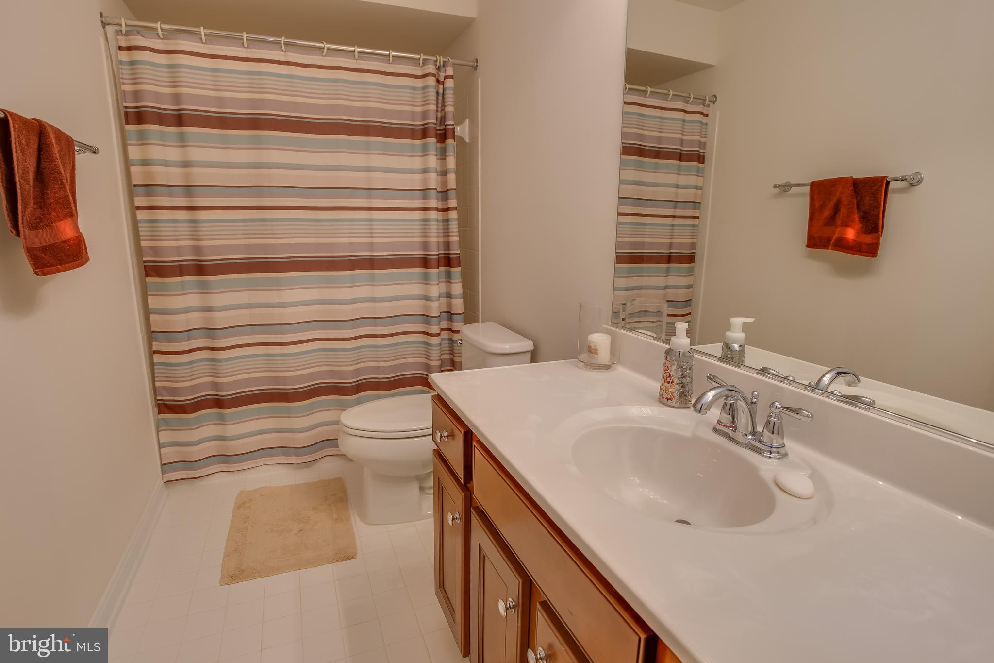 3437 Eagle Ridge Drive Woodbridge, VA 22191 - Photo 32 of 40 a bathroom with a sink a toilet and shower curtain