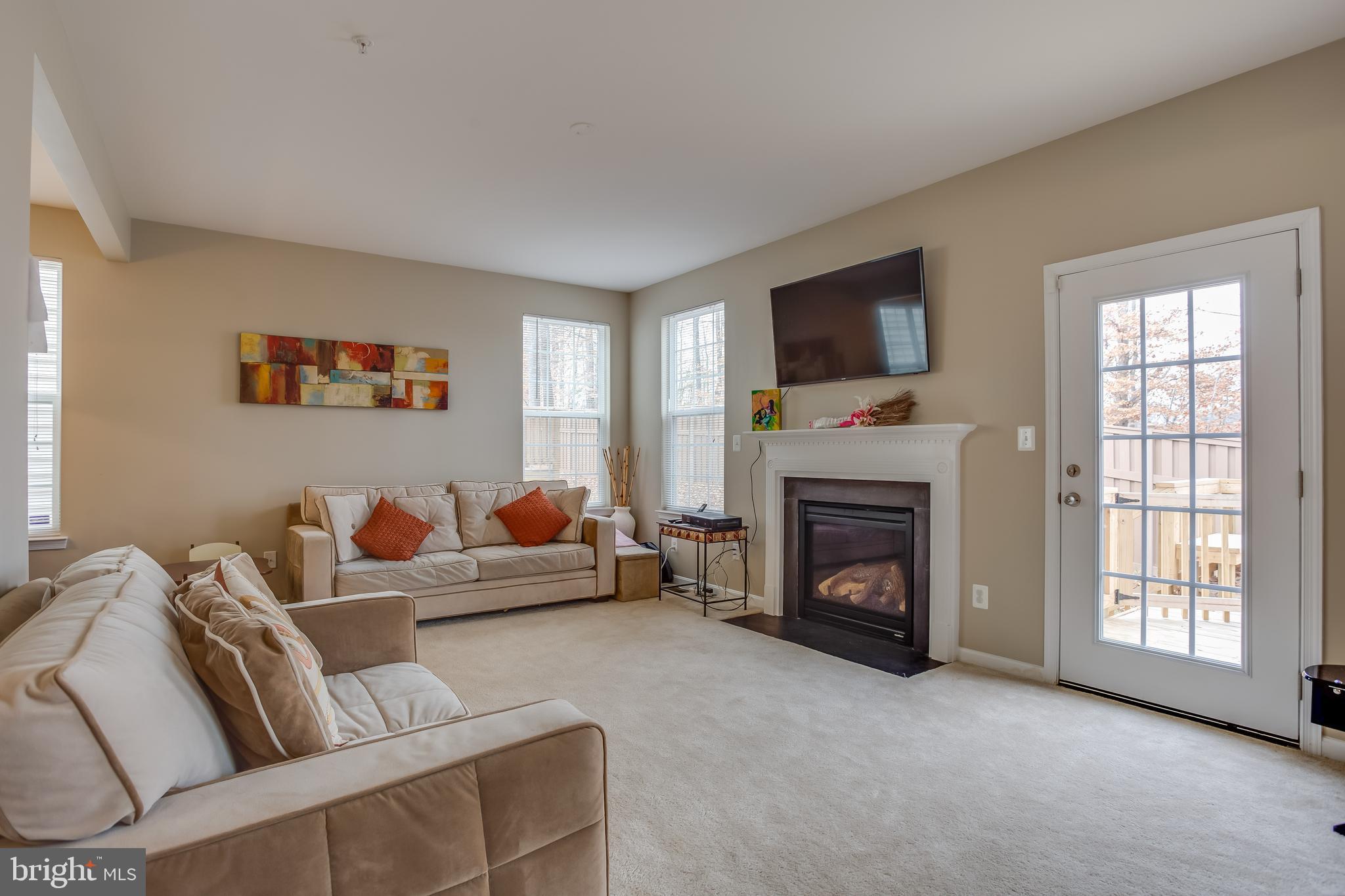 3437 Eagle Ridge Drive Woodbridge, VA 22191 - Photo 7 of 40 a living room with furniture a flat screen tv and a fireplace