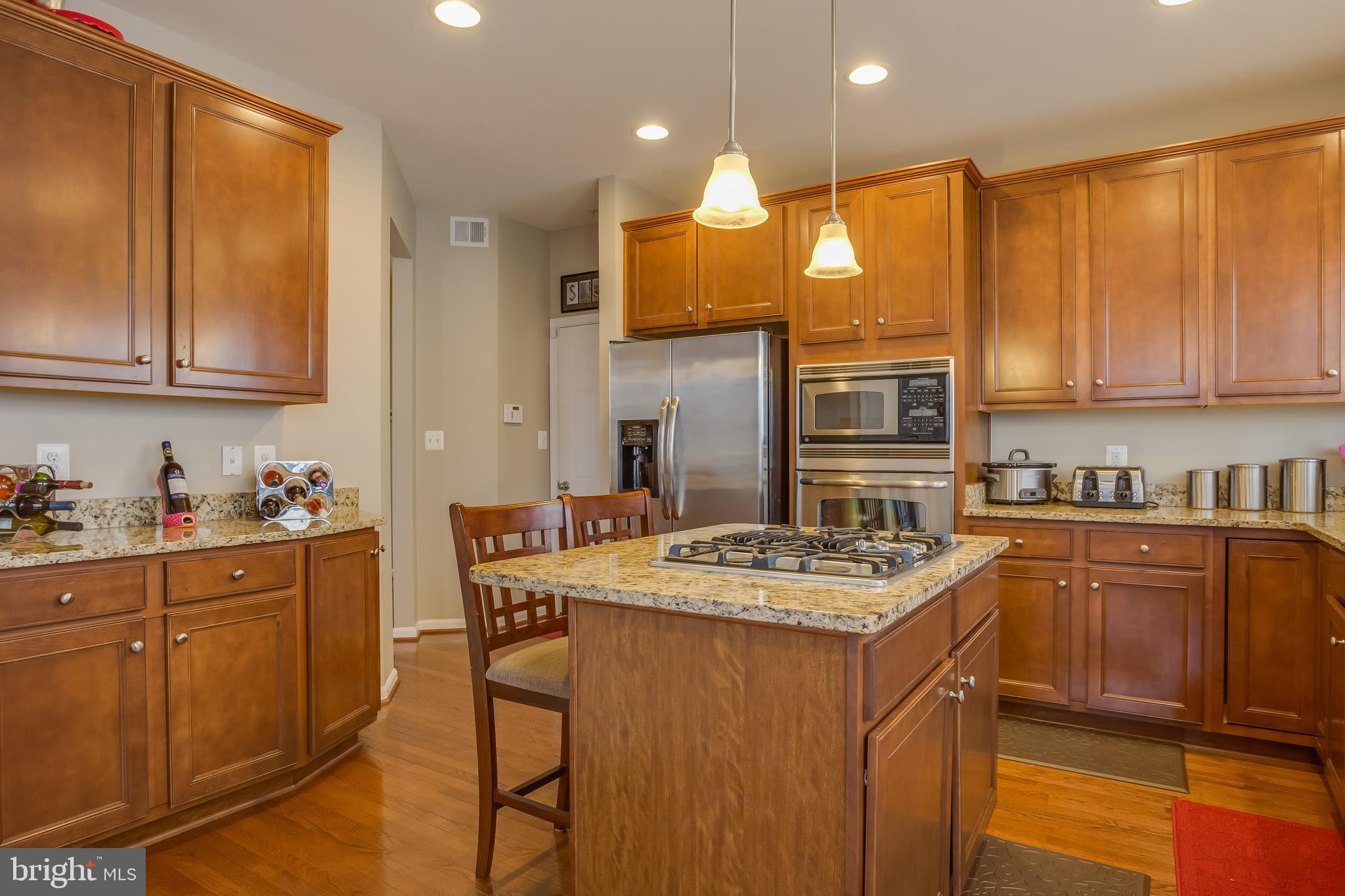 3437 Eagle Ridge Drive Woodbridge, VA 22191 - Photo 9 of 40 a kitchen with stainless steel appliances granite countertop a sink stove and cabinets