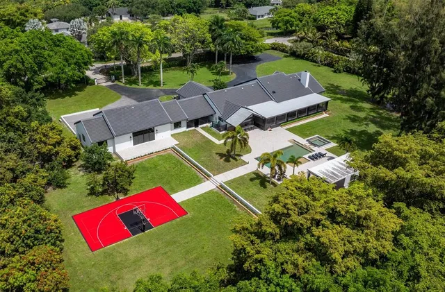 an aerial view of a house with pool outdoor seating and yard