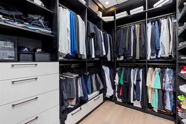 a bedroom with a large bed and a chandelier