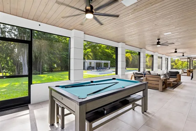 a living room with furniture and a floor to ceiling window