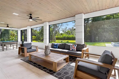 a living room with furniture and large windows