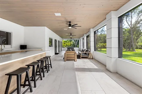 a view of a house with pool and chairs