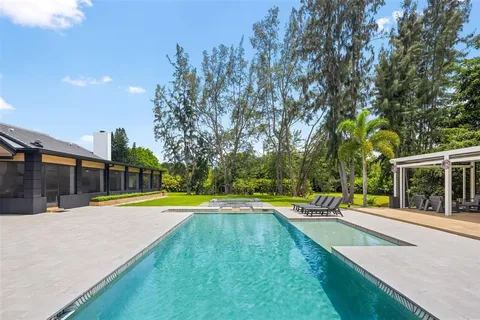 a living room with furniture and floor to ceiling windows