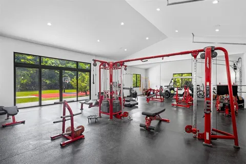 an aerial view of residential houses with outdoor space and street view