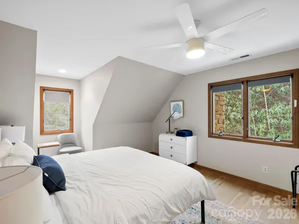 a bedroom with a bed and a painting on the wall