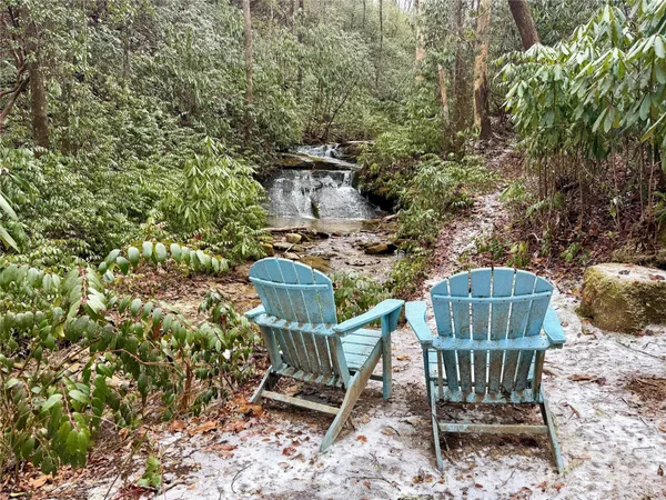 a view of a chairs and table in the backyard