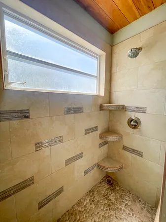 a bathroom with a toilet and a shower