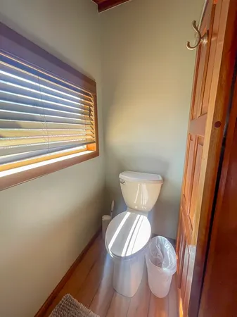 a toilet sitting in a bathroom next to a window