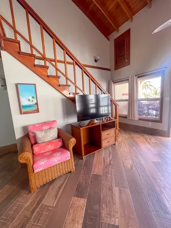 a living room with furniture and a wooden floor