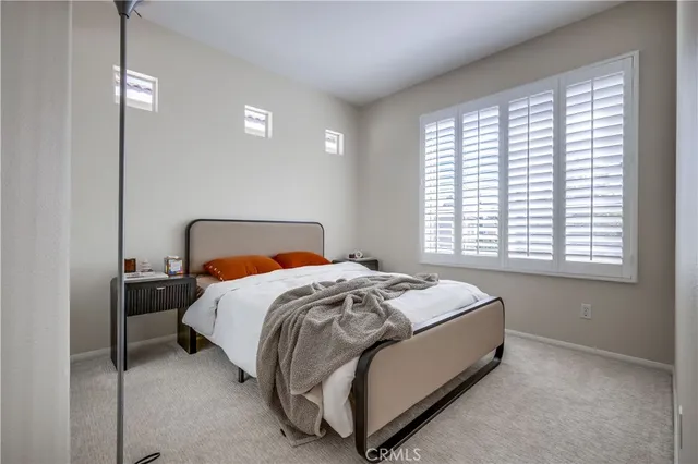 a bedroom with a bed and a lamp