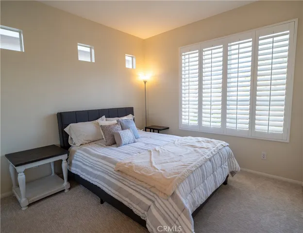 a bedroom with a bed and a chair