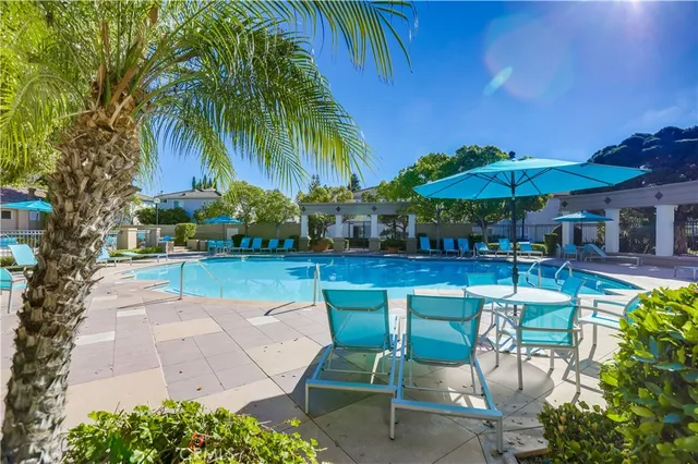 a view of a swimming pool with outdoor seating