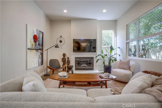 a living room with furniture a large window and a fireplace