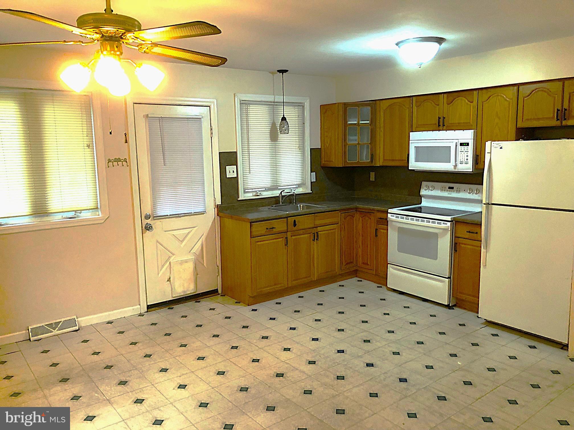 8 Roberts Lane Berlin, NJ 08009 - Photo 8 of 19 a kitchen with a cabinets a stove a sink and a refrigerator