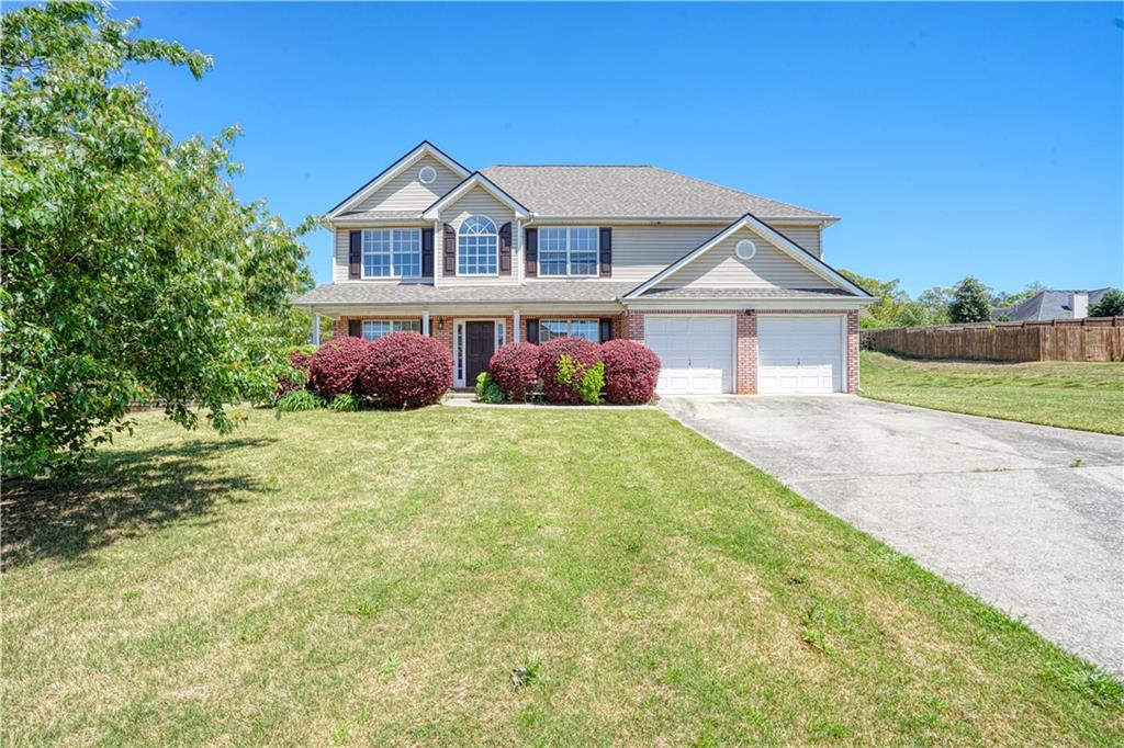 a front view of house with yard and green space