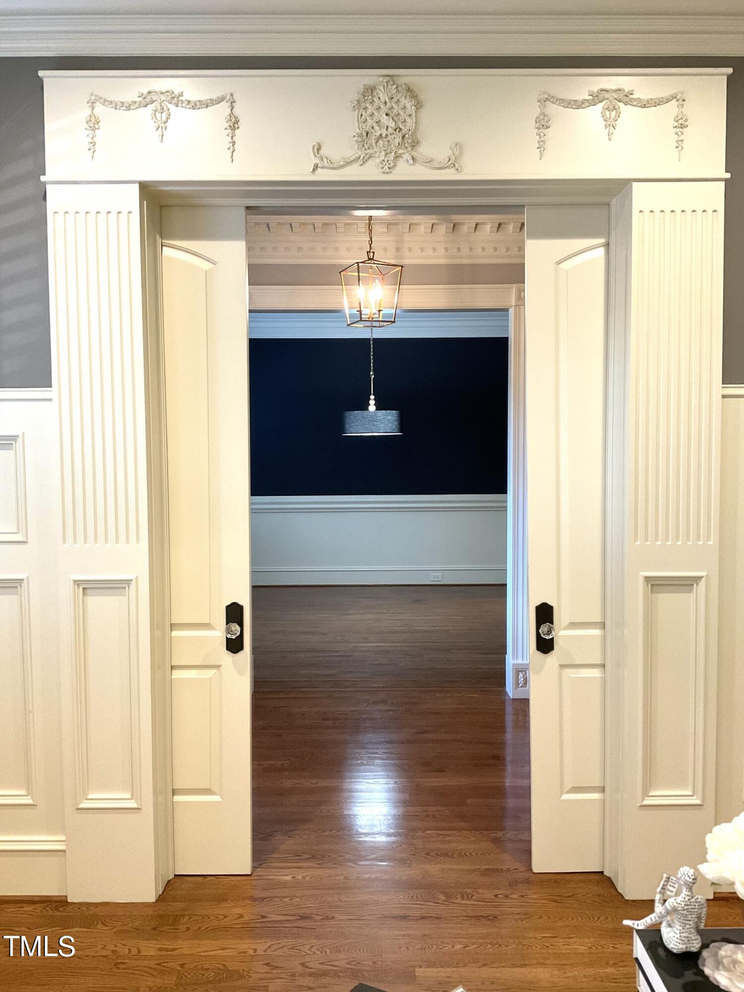 7814 Monument Lane Raleigh, NC 27615 - Photo 40 of 52 Note detailed millwork above office door into entrance hall, pocket doors
