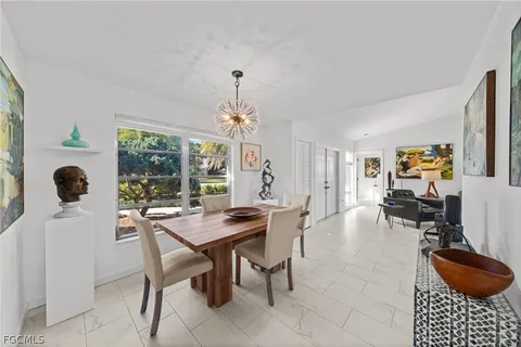 a bedroom with a bed wall painting and a window