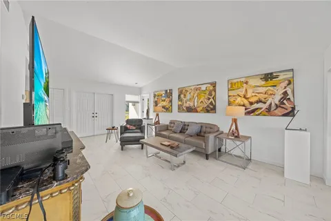 a large kitchen with white cabinets and stainless steel appliances