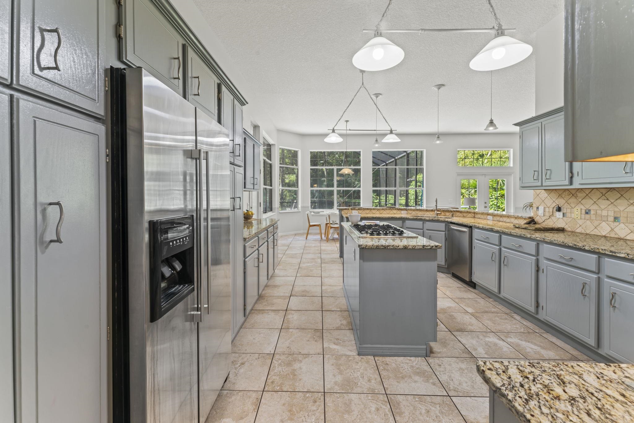 795 Kings Estate Road St. Augustine, FL 32086 - Photo 14 of 90 a kitchen with stainless steel appliances granite countertop a refrigerator a sink a stove and dishwasher