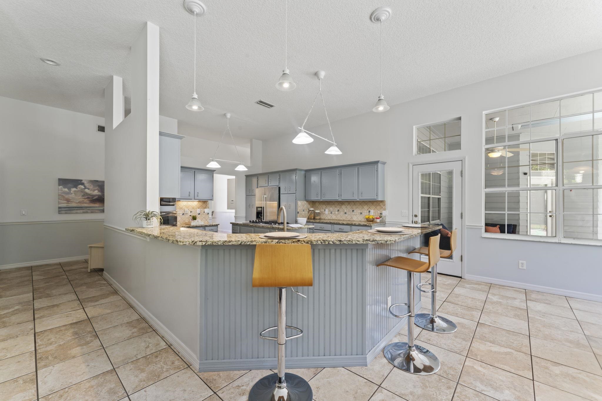795 Kings Estate Road St. Augustine, FL 32086 - Photo 21 of 90 a kitchen with a table and chairs in it