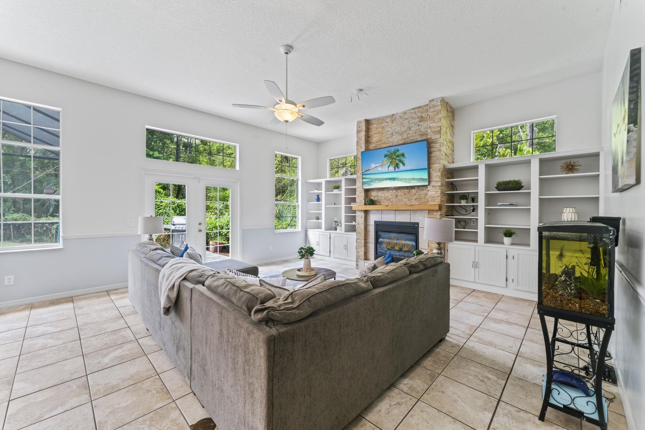 795 Kings Estate Road St. Augustine, FL 32086 - Photo 27 of 90 a living room with furniture a fireplace and a flat screen tv