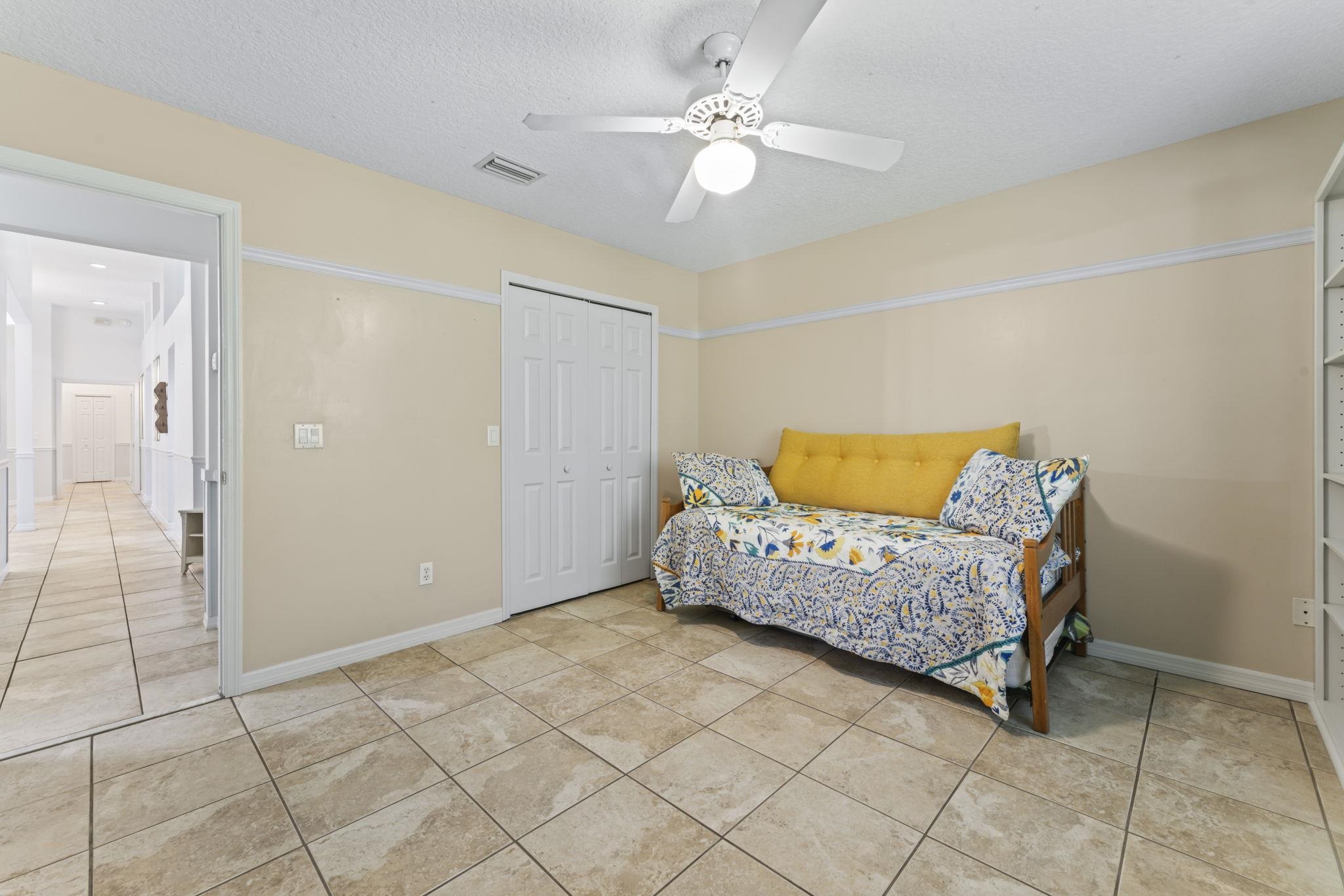 795 Kings Estate Road St. Augustine, FL 32086 - Photo 30 of 90 a bedroom with a bed and a chandelier