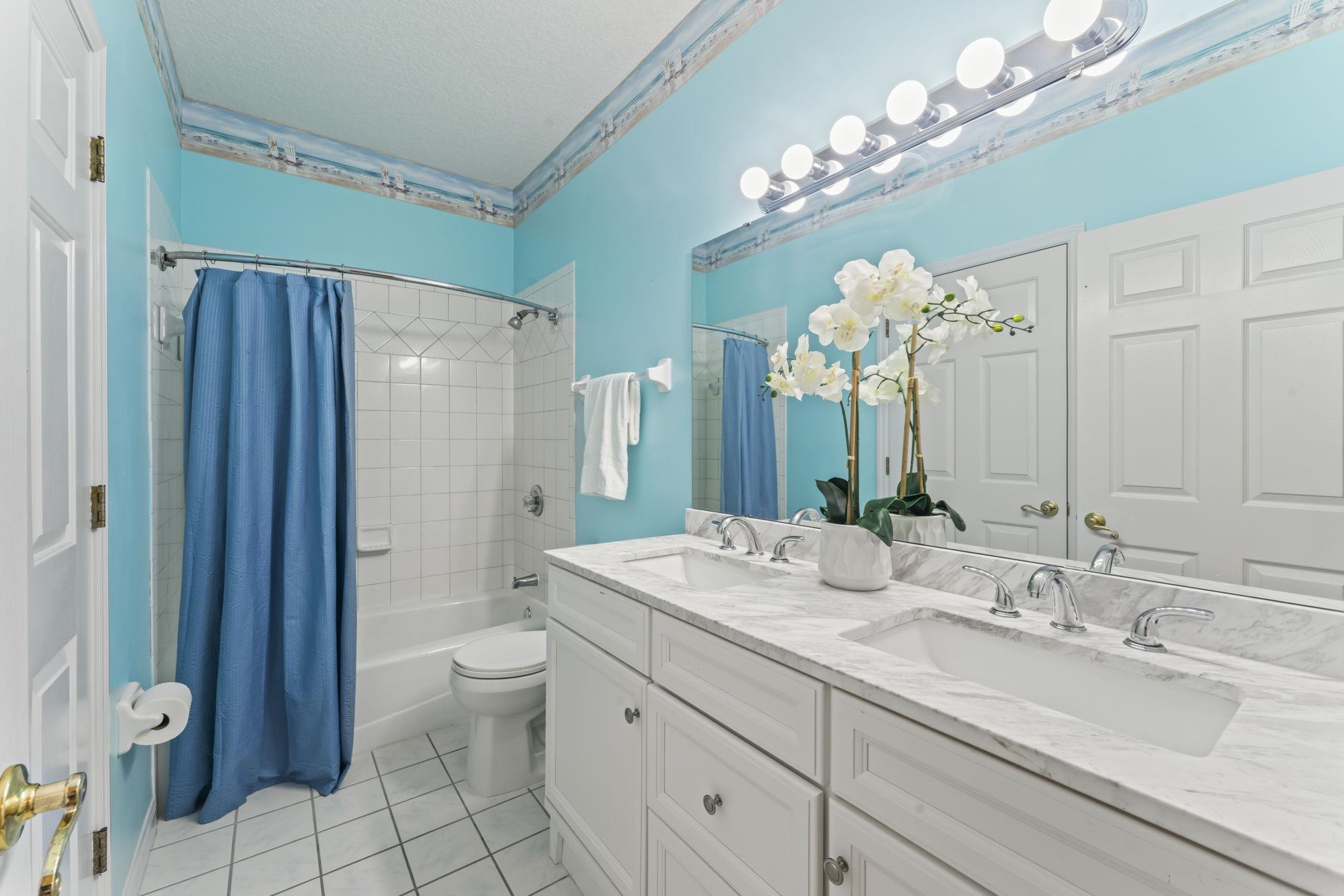 795 Kings Estate Road St. Augustine, FL 32086 - Photo 49 of 90 a bathroom with a granite countertop sink a toilet and a large mirror