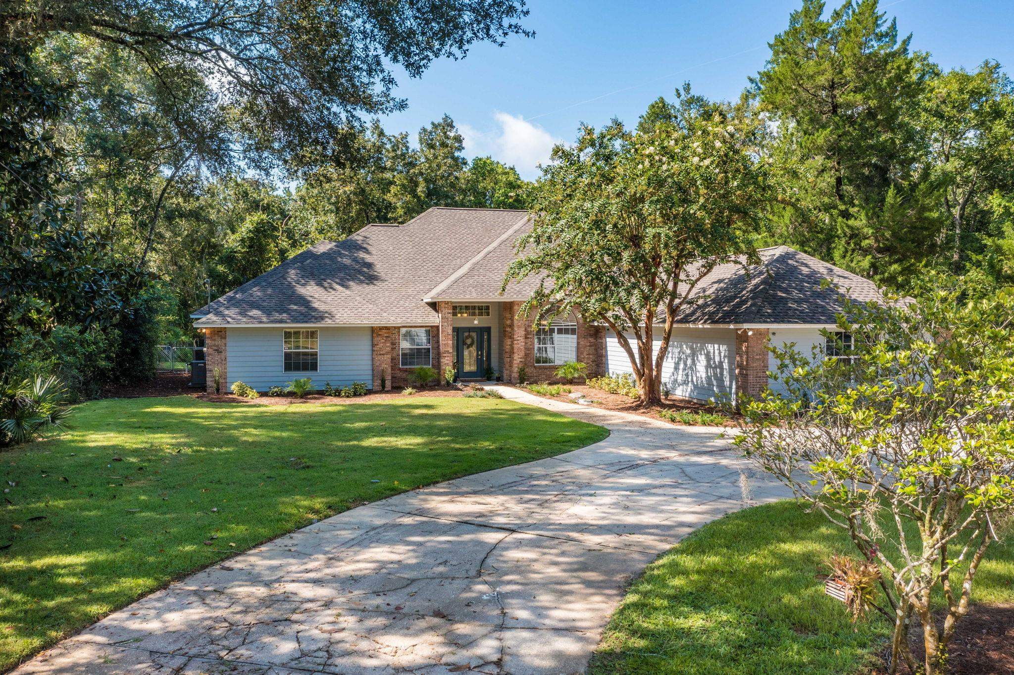 795 Kings Estate Road St. Augustine, FL 32086 - Photo 87 of 90 a front view of a house with a garden and trees