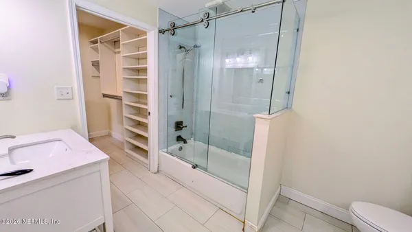 a bathroom with a shower and a sink